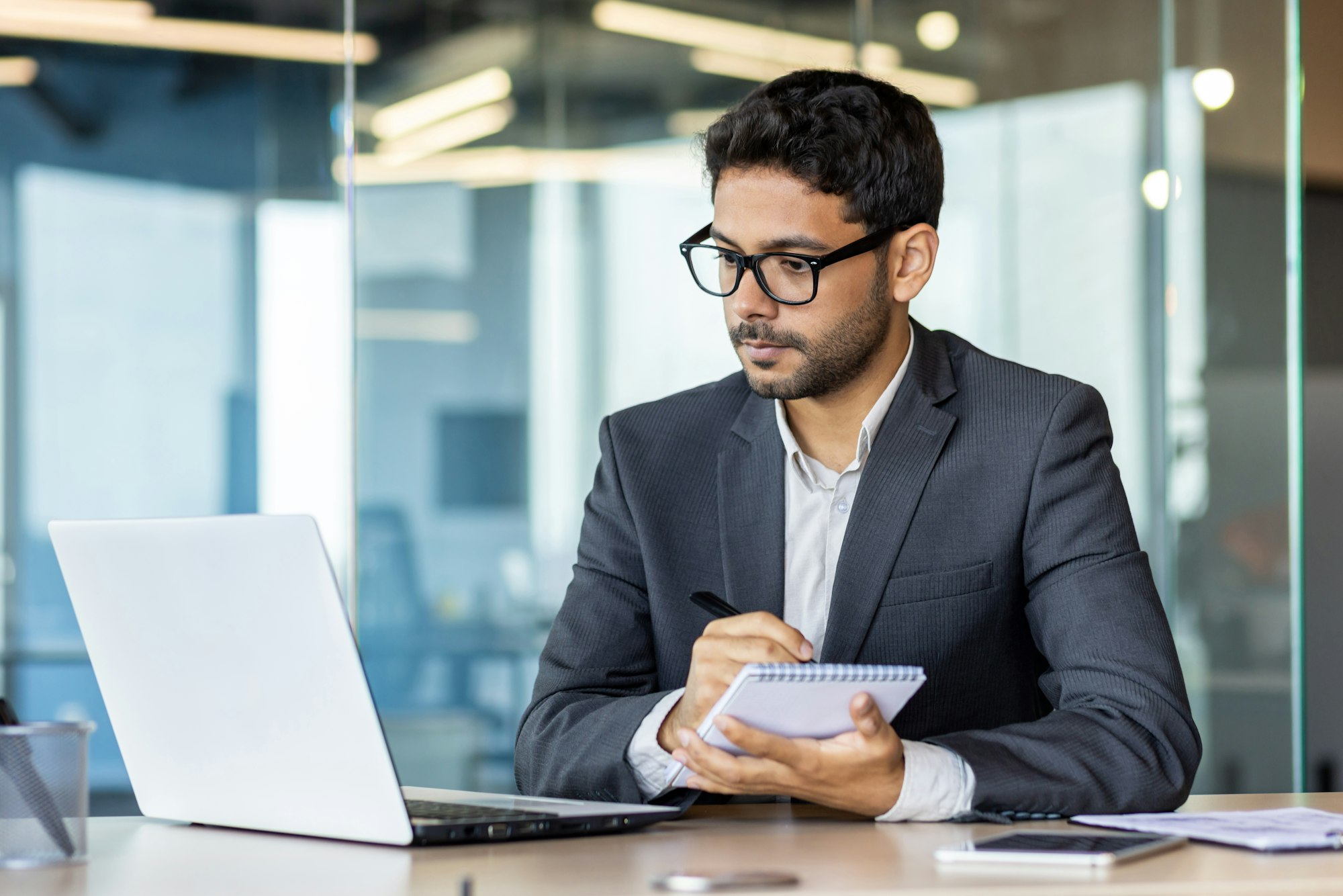 Serious and concentrated thinking businessman watching webinar online course, man upgrading at